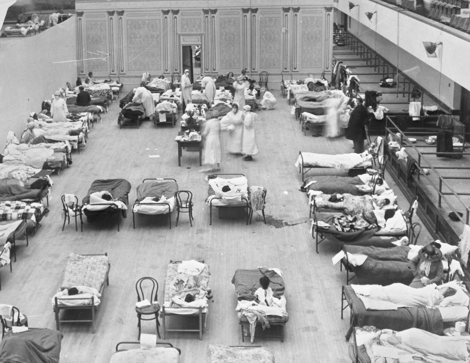 Red Cross nurses tend to flu patients in Oakland Municipal Auditorium in 1918.