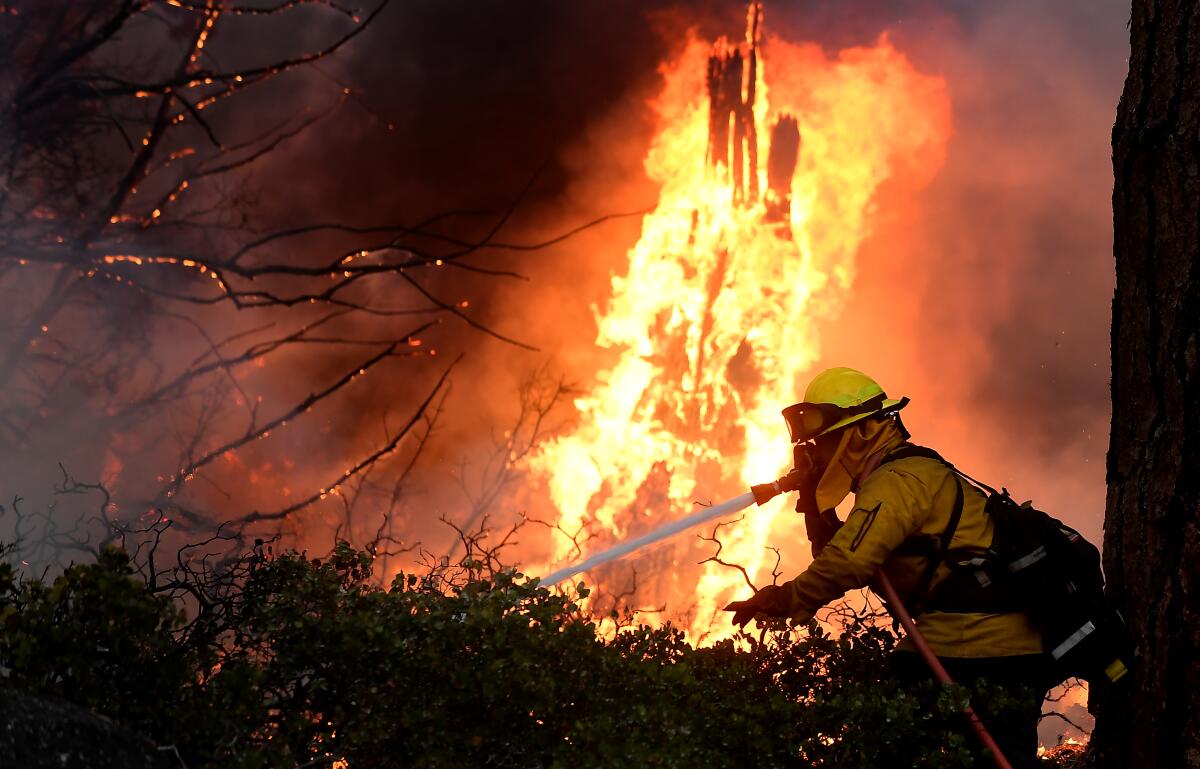 Firefighters battle the Caldor fire along highway 89 west of Lake Tahoe on Thursday.