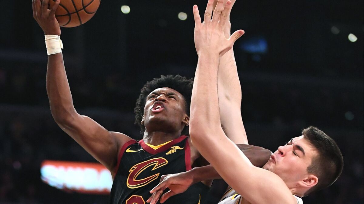 Lakers' Ivica Zubac forces Cleveland Cavaliers Colin Sexton into a missed shot buts gets an elbow to the face in the second quarter at the Staples Center on Sunday.