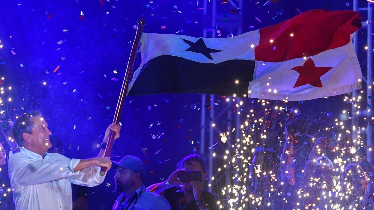 Laurentino Cortizo, of the Revolutionary Democratic Party waves a Panamanian flag during his closing campaign rally May 1 in Panama City.