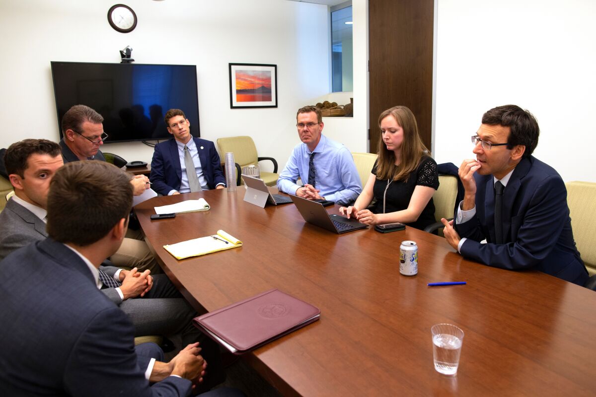 Ferguson confers with attorneys and other members of his staff on Sept. 19.