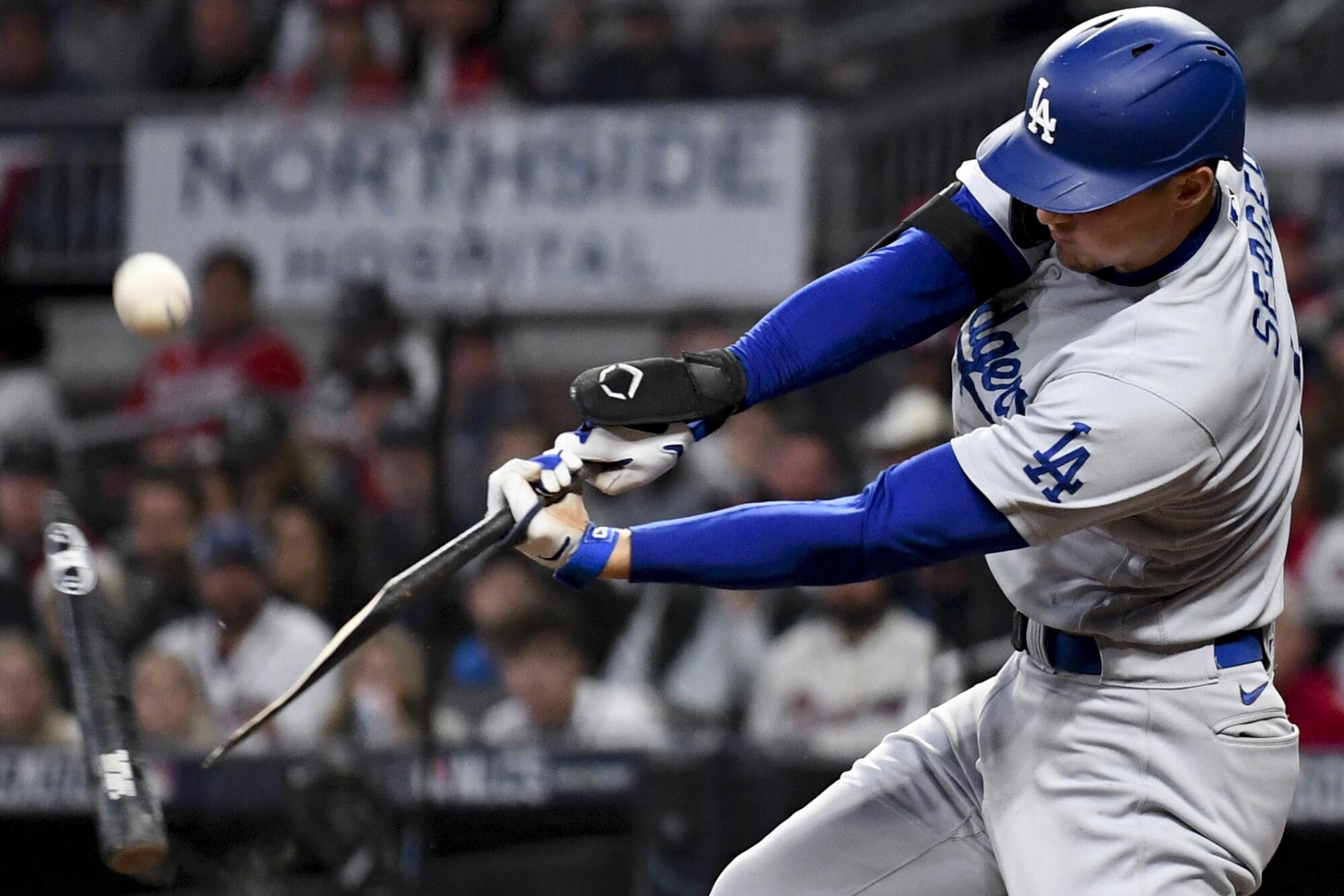 Los Angeles Dodgers' Corey Seager breaks his bat on a pop up fly for an out 