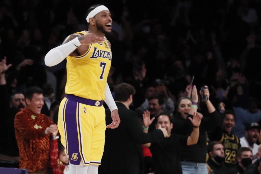 Lakers forward Carmelo Anthony (7) jumps in the air after hitting a three-pointer 