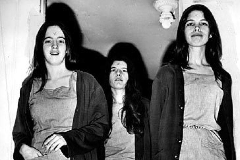 Manson followers Susan Atkins, left, Patricia Krenwinkel and Leslie Van Houten head into a morning court session in 1970. When Manson carved an "X" into his forehead during the trial, his "family" members followed suit.