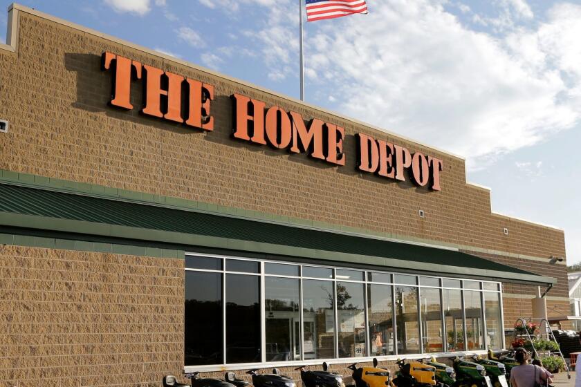 FILE - In this May 18, 2016, file photo, people approach an entrance to a Home Depot store in Bellingham, Mass. Home Depot is paying out one-time bonuses of up to $1,000 in cash to its hourly workers in the U.S., citing the recent tax overhaul. Home Depot Inc. said Thursday, Jan. 25, 2018, that the one-time bonus will be distributed in the current quarter. (AP Photo/Steven Senne, File)