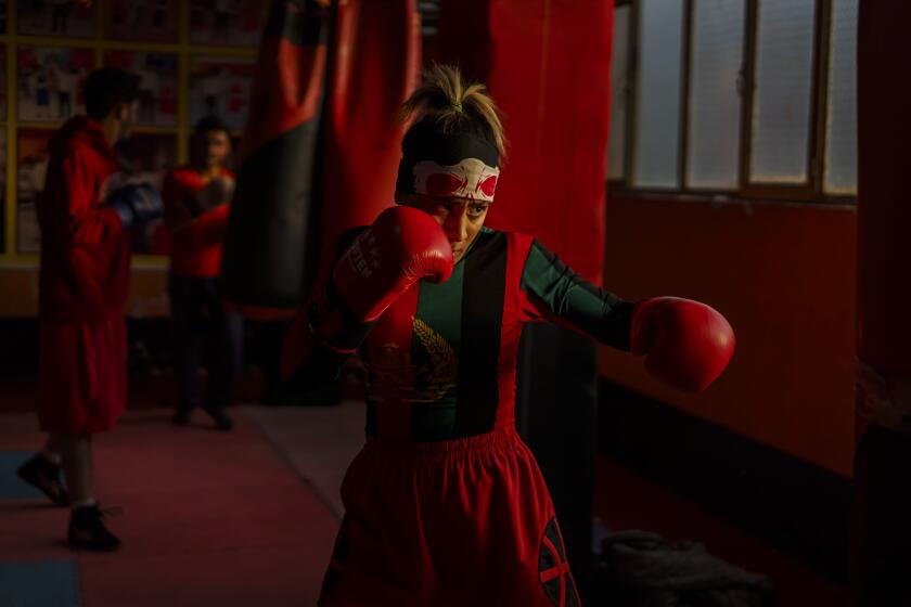 KABUL, AFGHANISTAN -- NOVEMBER 9, 2020: Khurshid Muhammadi, 16, trains for boxing at Berzhad Boxing Gym three times a week in Kabul, Afghanistan, on Monday Nov. 9, 2020. Many young people are adamant to stay and fight, hoping the Taliban -- if they return -- cannot rule a changed Kabul. Many others are determined to leave. OWhat will happen to our achievements?O says Khurshid Muhammadi, a player on the ten-year-old Afghan womenOs national soccer team. OWe may not be able to work and again have to wear head-to-toe burqas the Taliban once forced women to wear in public.O(Marcus Yam / Los Angeles Times)