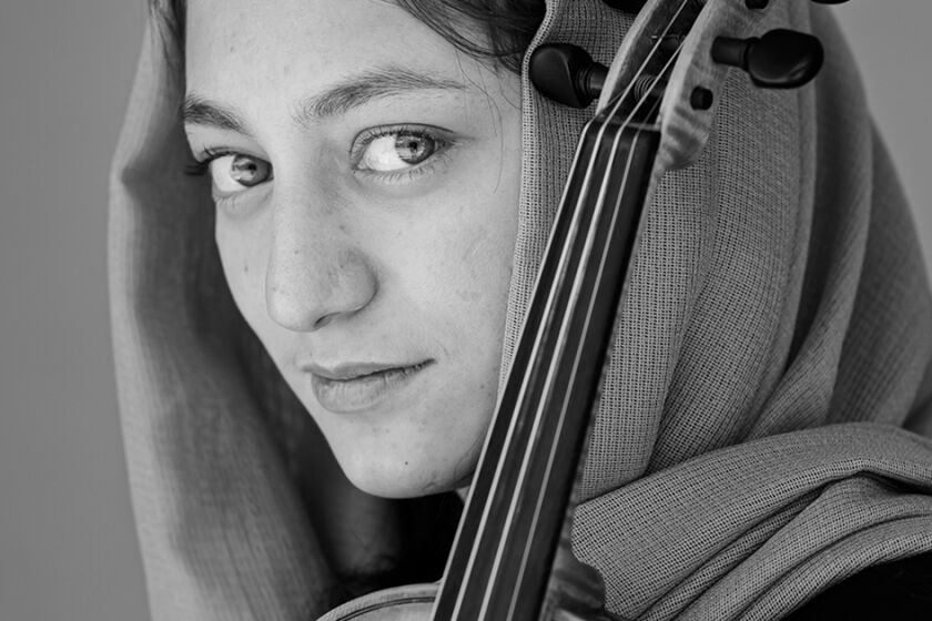 ##FIRST NAMES ONLY, MEMBERS OF ZOHRA ORCHESTRA IN AFGHANISTAN. PLEASE DO NOT PUBLISH UNLESS HAVE PERMISSION FROM PHOTO EDITORS## KABUL, AFGHANISTAN -- MAY 19, 2021: Sunbol, on the violin, a member Zohra, AfghanistanOs all-female orchestra, poses for a portrait at the Afghanistan National Institute of Music, before it was shuttered when the Taliban took over the country and turned the campus into one of their outposts, in Kabul, Afghanistan, Wednesday, May 19, 2021. (MARCUS YAM / LOS ANGELES TIMES)