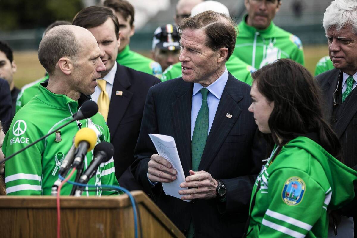 Monte Frank, left, of Newtown, Conn., gives Sen. Richard Blumenthal (D-Conn.) letters supporting gun control efforts in Congress.