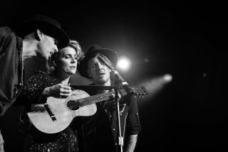 A photograph of Phil Hanseroth, Brandi Carlile, Tim Hanseroth.