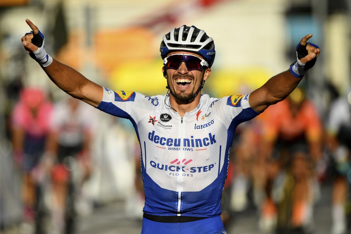 France's Julian Alaphilippe crosses the finish line to win the second stage of the Tour de France.