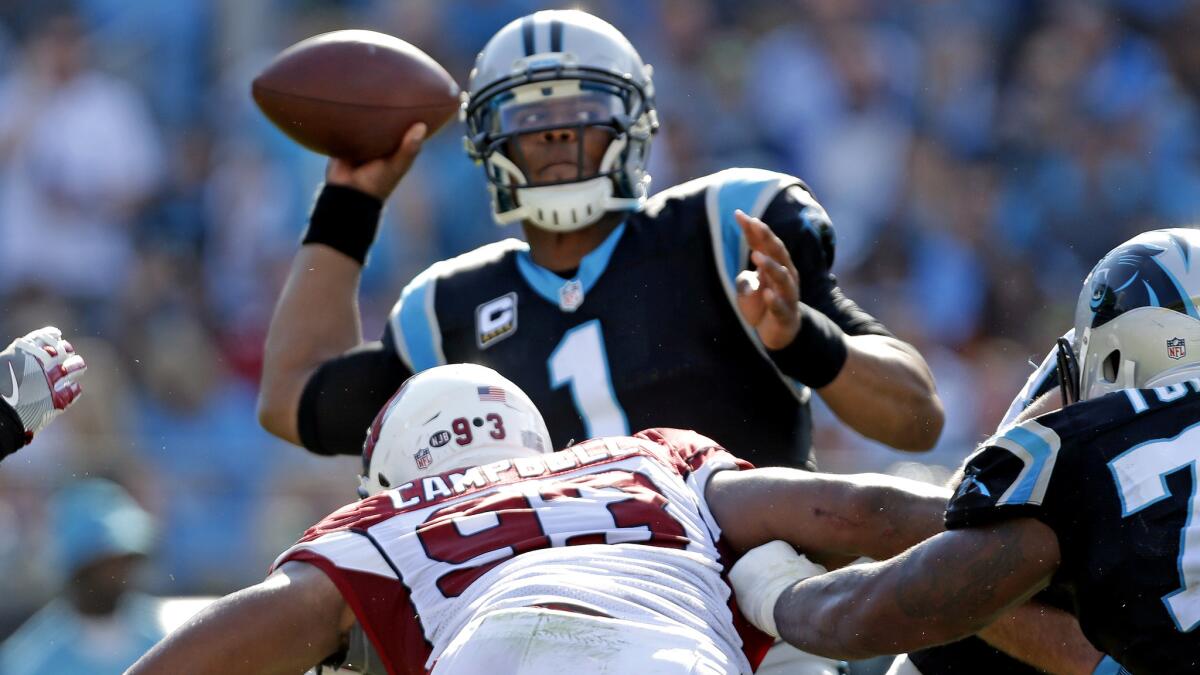 Panthers quarterback Cam Newton, shown passing against the Arizona Cardinals, has been critical this season from some hits he's taken both in and out of the pocket.