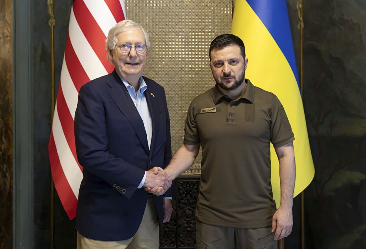 In this handout photo provided by the Ukrainian Presidential Press Office, Ukrainian President Volodymyr Zelenskyy and Senate Minority Leader Mitch McConnell, R-Ky., pose for a photo in Kyiv, Ukraine, Saturday, May 14, 2022. (Ukrainian Presidential Press Office via AP)
