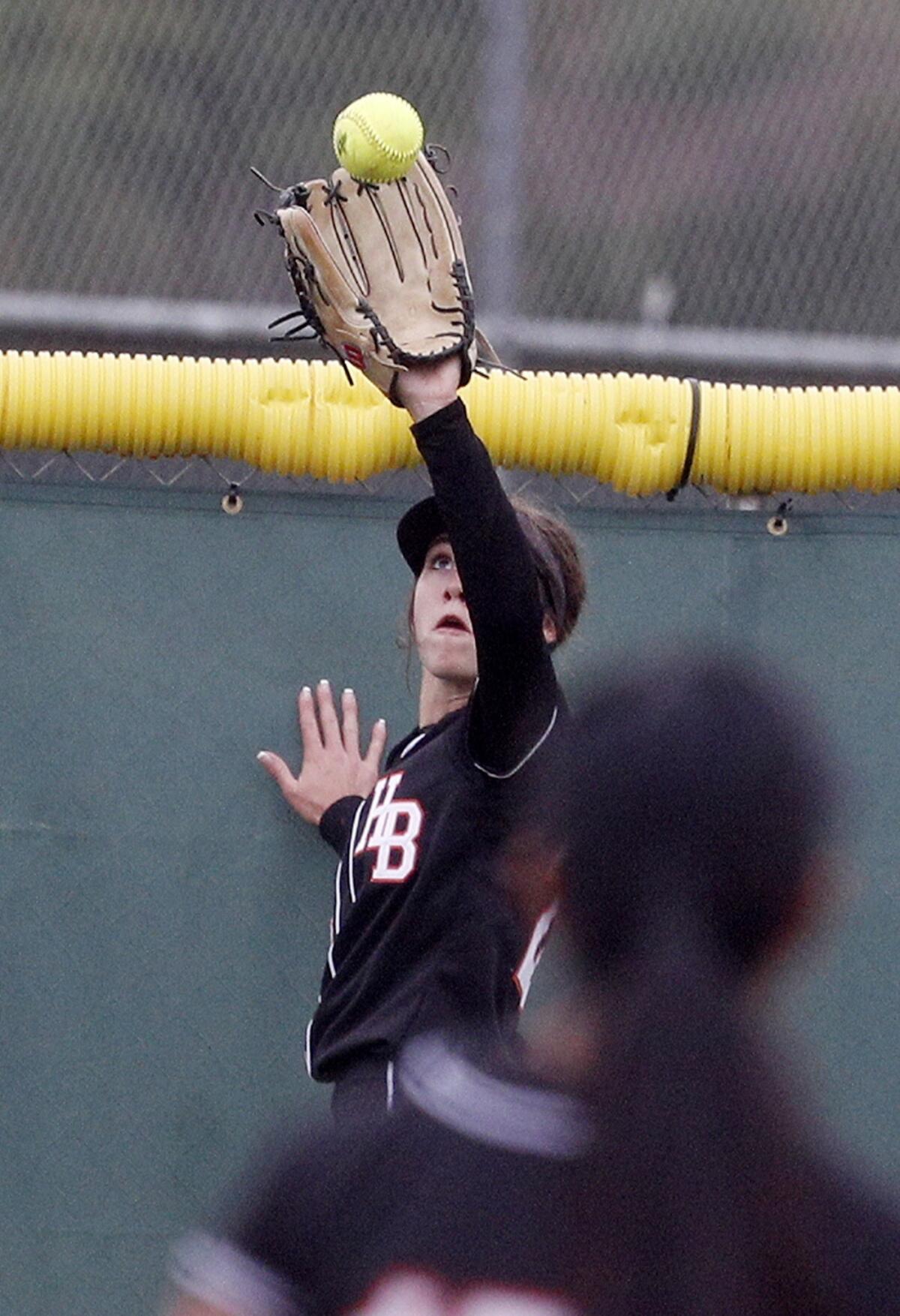 Huntington Beach center fielder Jadelyn Allchin catches a deeply hit fly ball in a CIF Southern Section Division 1 quarterfinal playoff game at Chino Hills on May 9.