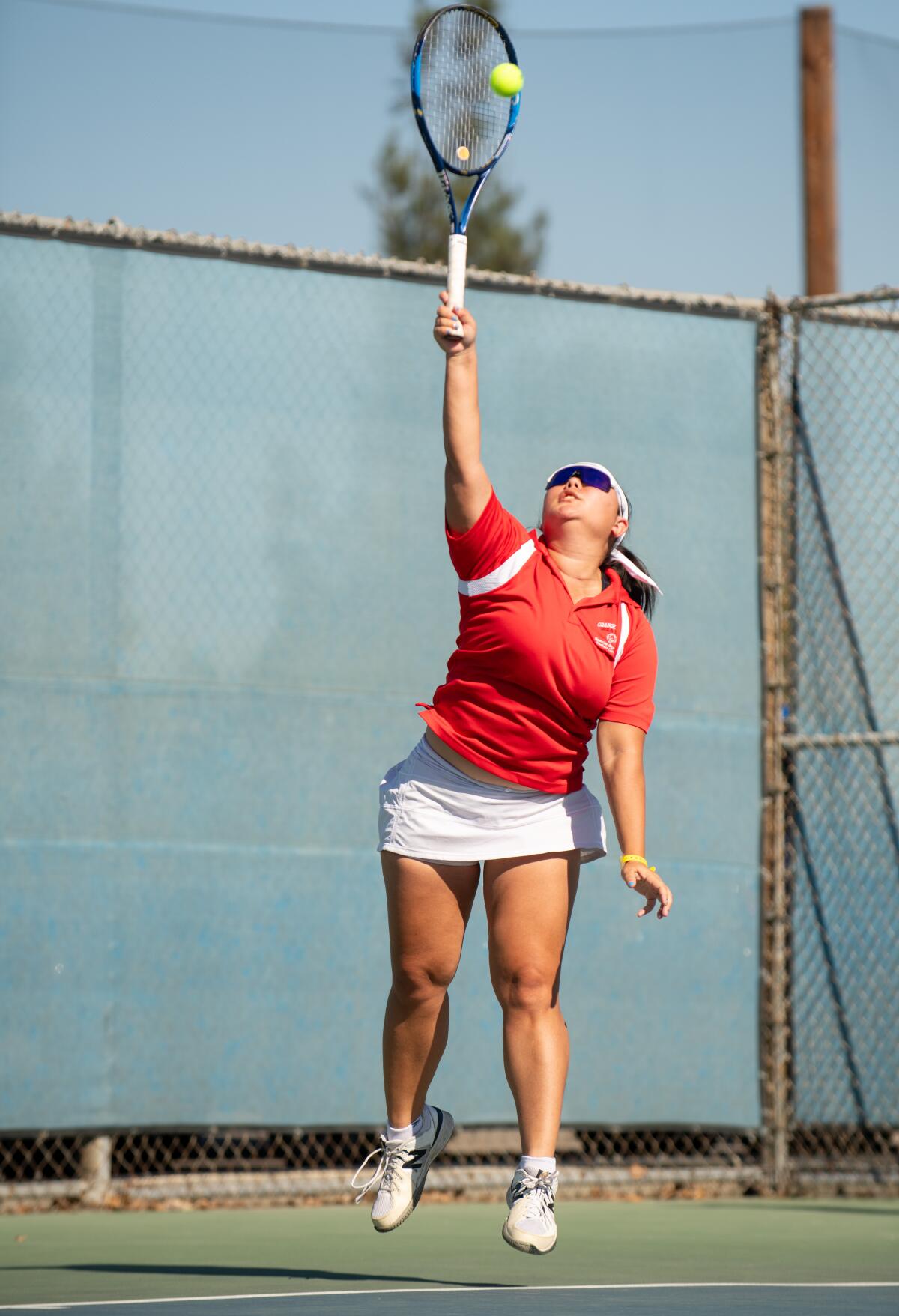 Kaitlin Tsue of OC Tigers tennis serves at the Special Olympics Southern California Fall Games.