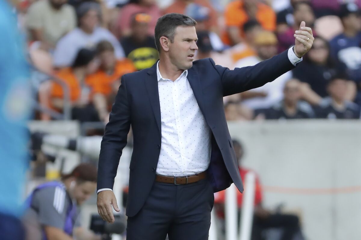 Galaxy coach Greg Vanney motions to his players during the first half of a match against the Houston Dynamo.