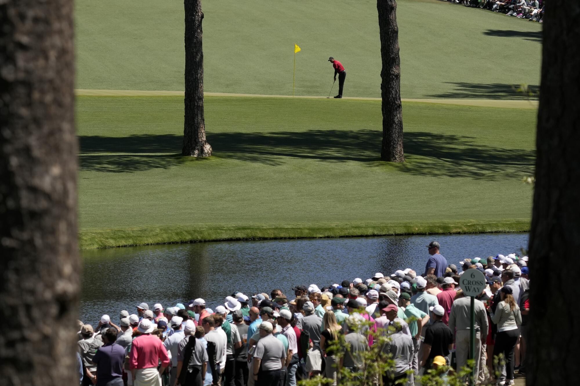 Tiger Woods putts on the 15th green during the final round.