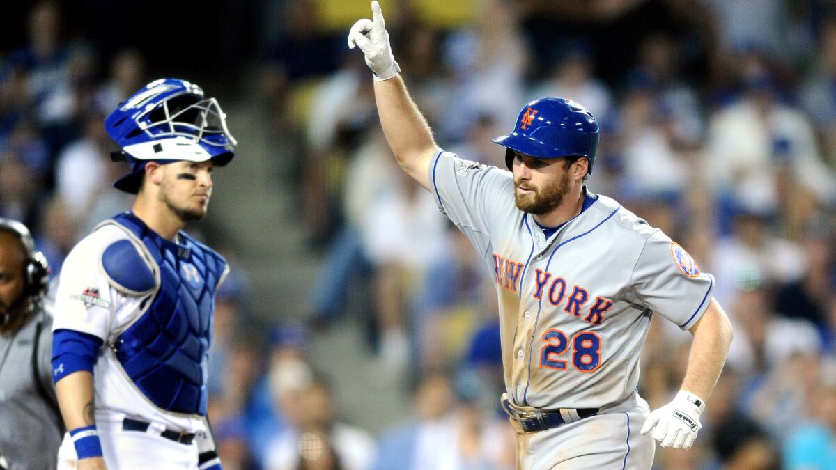 Mets second baseman Daniel Murphy celebrates as he crosses home plate after hitting a solo home run against the Dodgers in the sixth inning of Game 5.