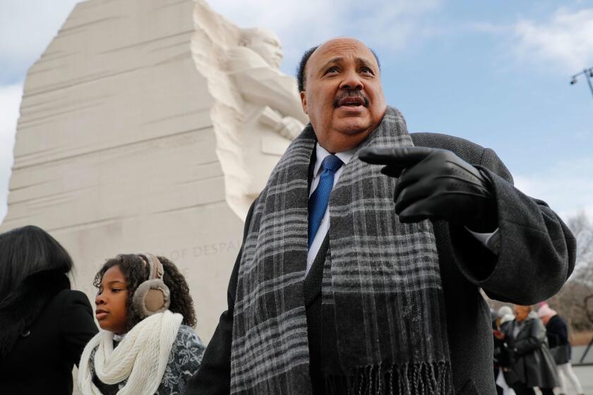 Martin Luther King III, right, with his wife Arndrea Waters, left, and their daughter Yolanda, 9, center, during their visit to the Martin Luther King Jr., Memorial on the National Mall in Washington, Monday, Jan. 15, 2018. The son of the late U.S. civil rights activist Martin Luther King Jr., and his family had earlier participated in an event commemorating the life and legacy of his father. (AP Photo/Pablo Martinez Monsivais)