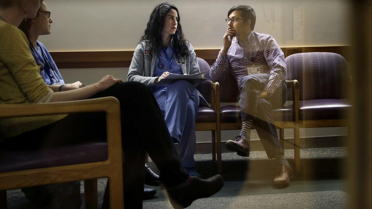 First-year doctors talk during "sign-out" at the hospital in Cambridge, Mass. on Feb. 27, 2017.