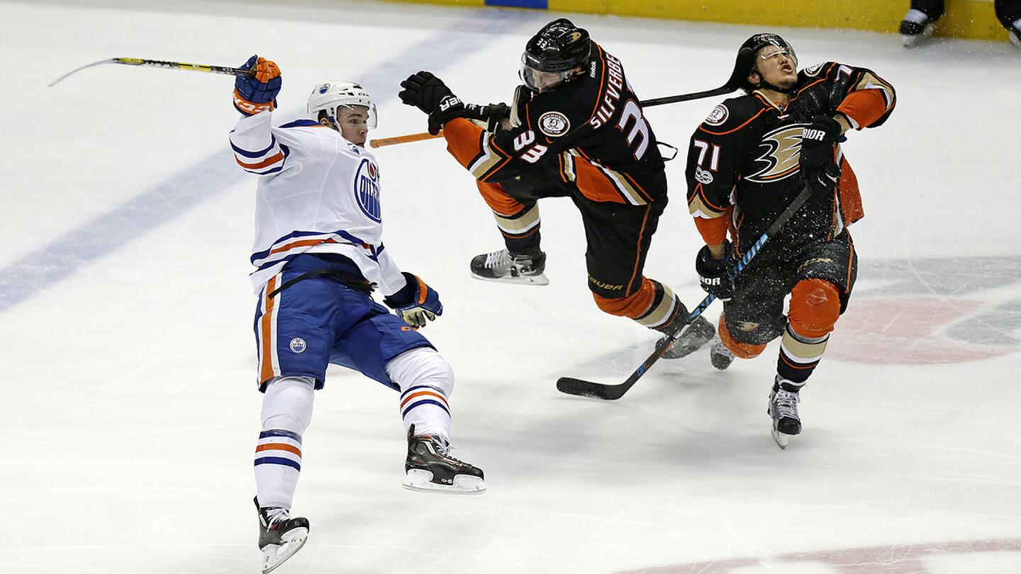 Ducks left wing Jakob Silfverberg (33) and defenseman Brandon Montour (71) collide while double-team Oilers center Connor McDavid (97) during the second period of Game 2.
