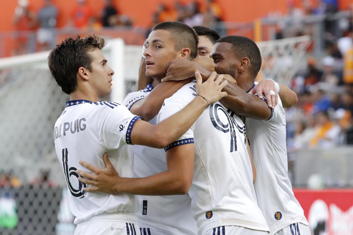 Galaxy forward Dejan Joveljic celebrates with teammates after scoring against Houston.