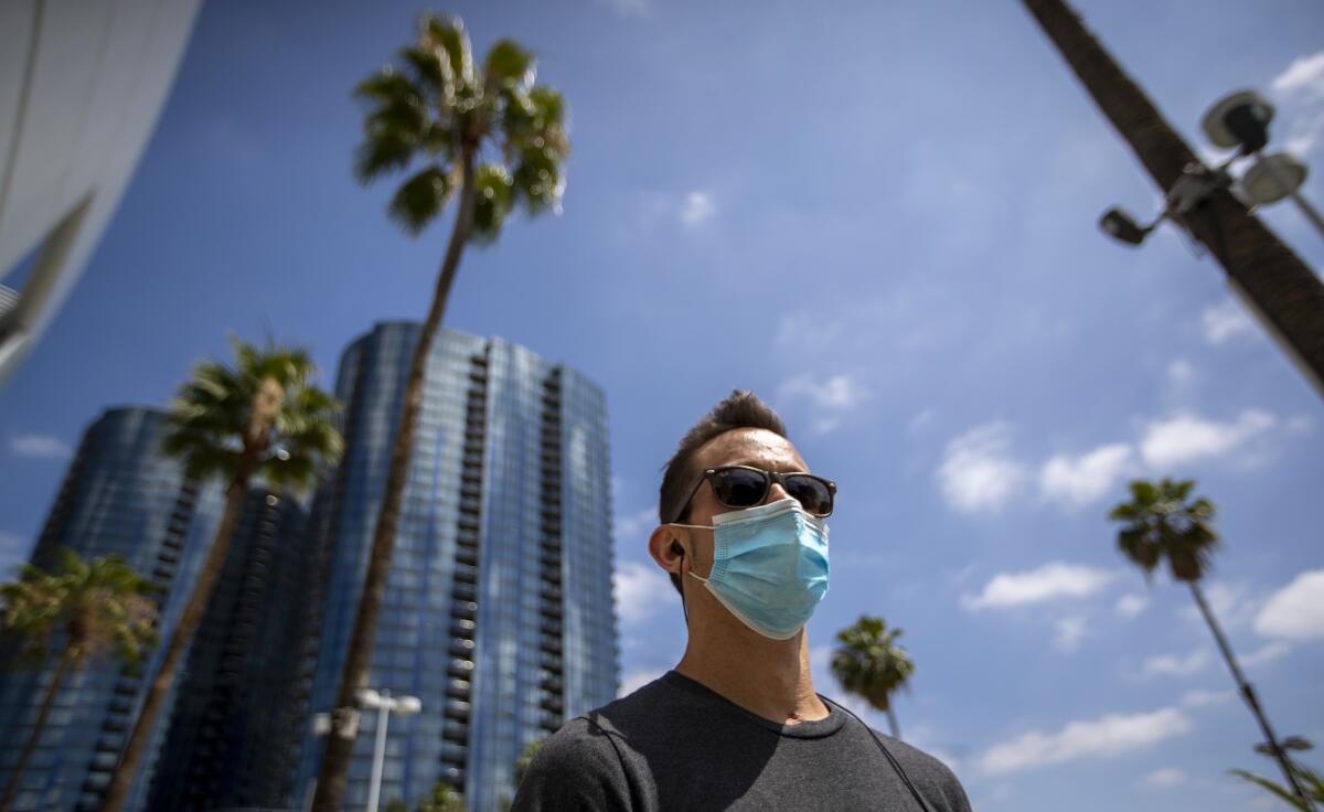 Brandon Leslie, an RN working with COVID-19 patients at Good Samaritan Medical Center, wears a protective face mask.