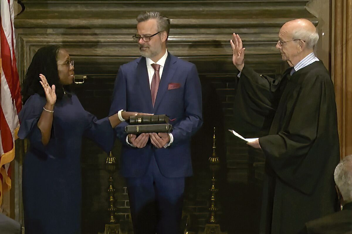 In this image from video provided by the Supreme Court, retired Supreme Court Associate Justice Stephen Breyer administers the Judicial Oath to Ketanji Brown Jackson as her husband Patrick Jackson holds the Bible at the Supreme Court in Washington, Thursday, June 30, 2022. (Supreme Court via AP)