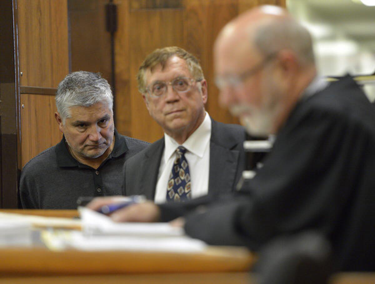 Former George De La Torre Jr. Elementary fourth-grade teacher Robert Pimentel, left, with attorney Richard Knickerbocker, center, is arraigned in Judge James Otto's courtroom at Los Angeles County Superior Court in Long Beach.