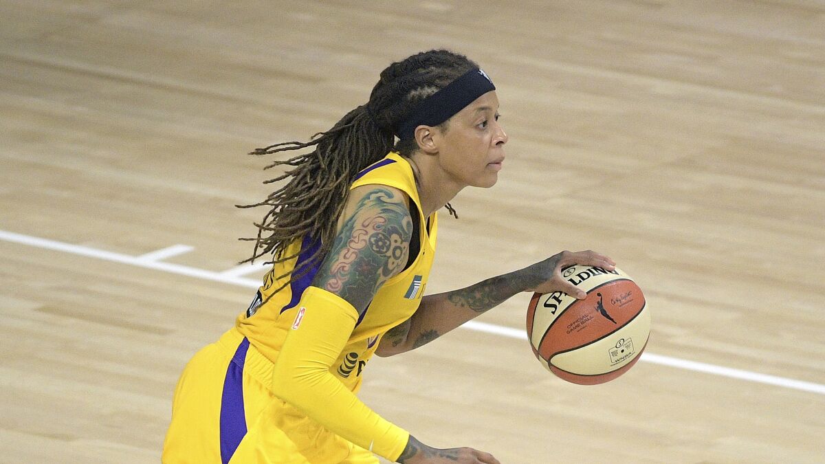 FILE - Los Angeles Sparks guard Seimone Augustus (33) brings the ball up the court during the first half of a WNBA basketball game against the Phoenix Mercury, Saturday, July 25, 2020, in Bradenton, Fla. LSU’s most decorated female student-athlete will become the first in school history to get her own statue. LSU announced Monday, April. 11, 2022, that women’s basketball legend Augustus’ statue will stand outside the Pete Maravich Assembly Center and join the likenesses of Pete Maravich, Bob Pettit and Shaquille O’Neal as former Tiger greats honored in such a way. (AP Photo/Phelan M. Ebenhack, File)