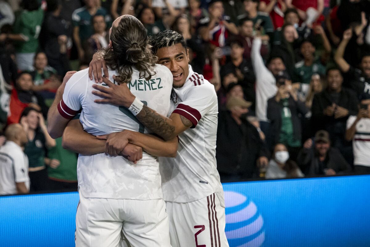 Mexico forward Santiago Tomas Gimenez, left, is congratulated by Julian Vicente Araujo during the first half of the team's international friendly soccer match against Chile, Wednesday, Dec. 8, 2021, in Austin, Texas. (AP Photo/Michael Thomas)