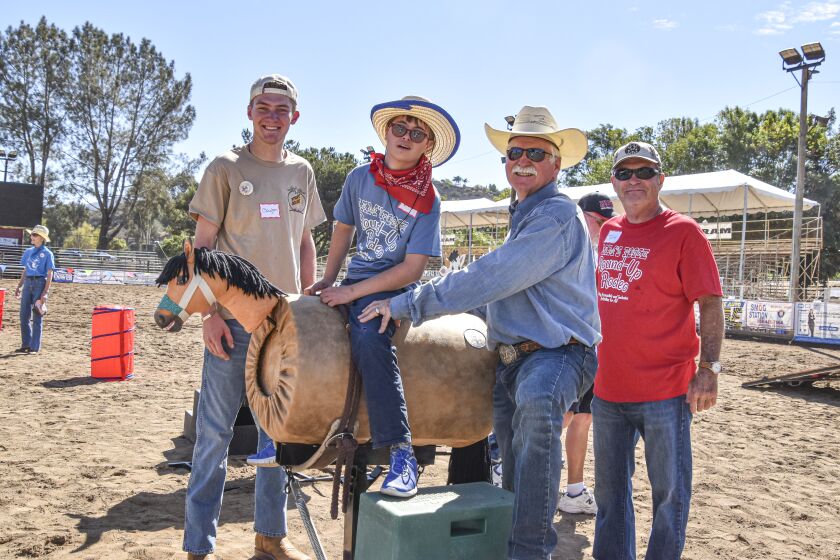 From left, volunteer Clayton Tellier, Jacob; Buck Burt, Sam’s Posse Founder; and volunteer Tom Drew.