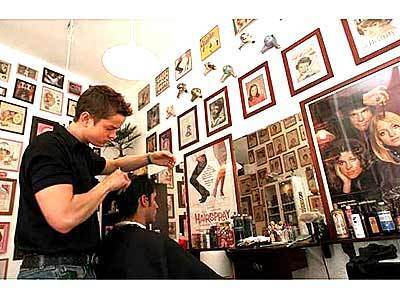 Stylist and history lover Jeff Hafler, 29, works on client Tim McElwee at his West Hollywood beauty salon Ohio, where eclectic hair collectibles are on display.