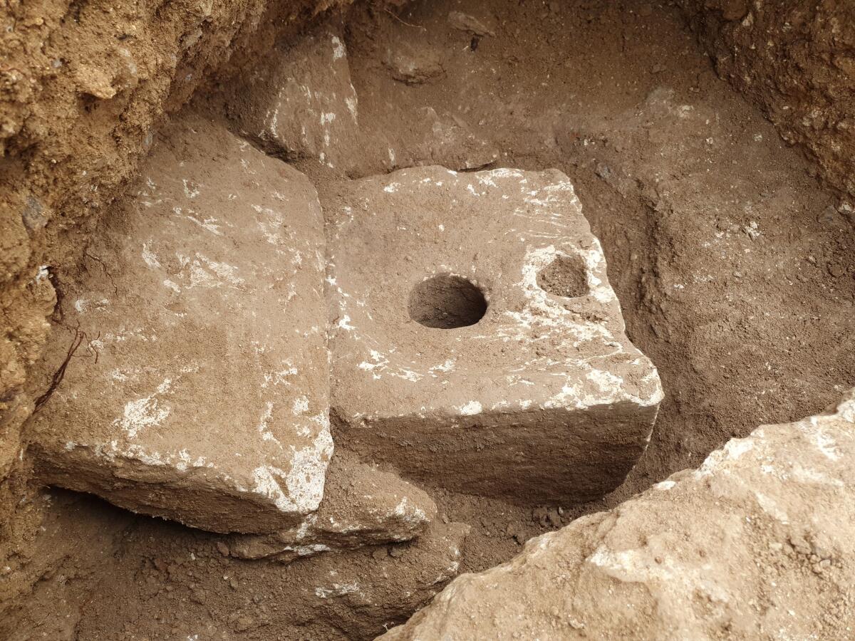 In this photo provided by Israel Antiquities Authority shows a rare ancient toilet in Jerusalem dating back more than 2,700 years Jerusalem, when private bathrooms were a luxury in the holy city, Tuesday, Oct. 5, 2021. The Israeli Antiquities Authority said on Tuesday that the smooth, carved limestone toilet was found in a rectangular cabin that was part of a sprawling mansion overlooking what is now the Old City. (Yoli Schwartz/Israel Antiquities Authority via AP)