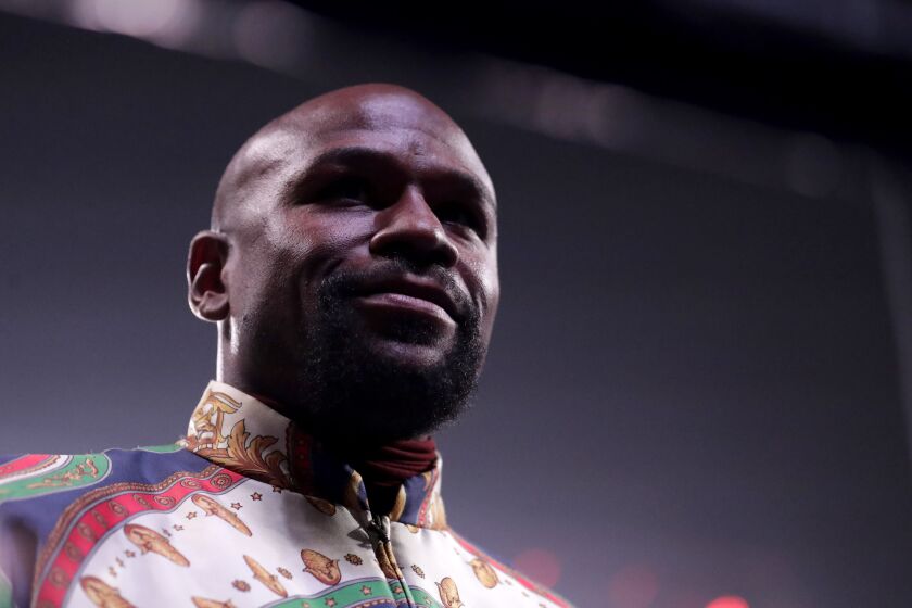 Floyd Mayweather looks on from the ring prior to a super featherweight boxing championship bout between Ricardo Nunez and Gervonta Davis, Saturday, July 27, 2019, in Baltimore. (AP Photo/Julio Cortez)