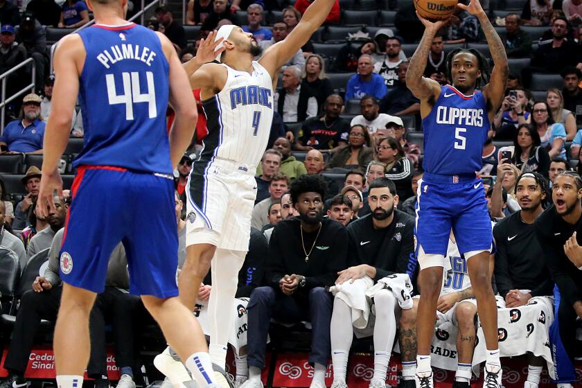 Los Angeles, CA - Clippers guard Bones Hyland shoots a three-pointer against Orlando guard Jalen Suggs in the fourth quarter of a regular season game at Crypto.com Arena in Los Angeles on Tuesday night, Oct. 31, 2023. . (Luis Sinco / Los Angeles Times)