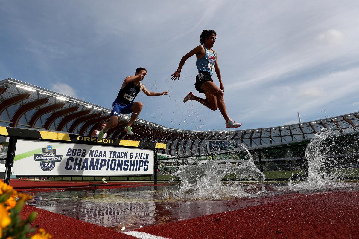 Loyola Marymount's Estanis Ruiz soars in the air as he competes in the 3,000-meter steeplechase event.