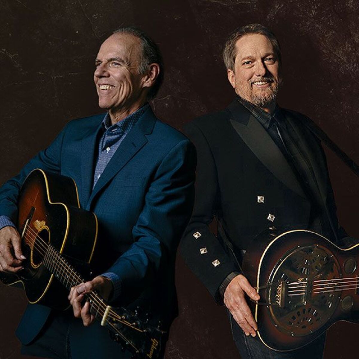 John Hiatt and Jerry Douglas standing side by side, holding guitars