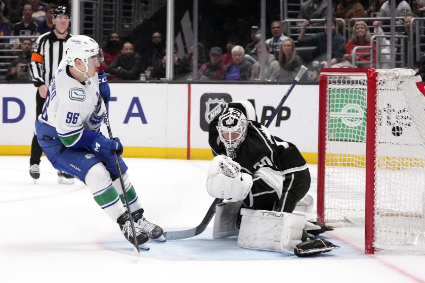 The Canucks' Andrei Kuzmenko (96) scores past Kings goalie Joonas Korpisalo during the shootout March 18, 2023.