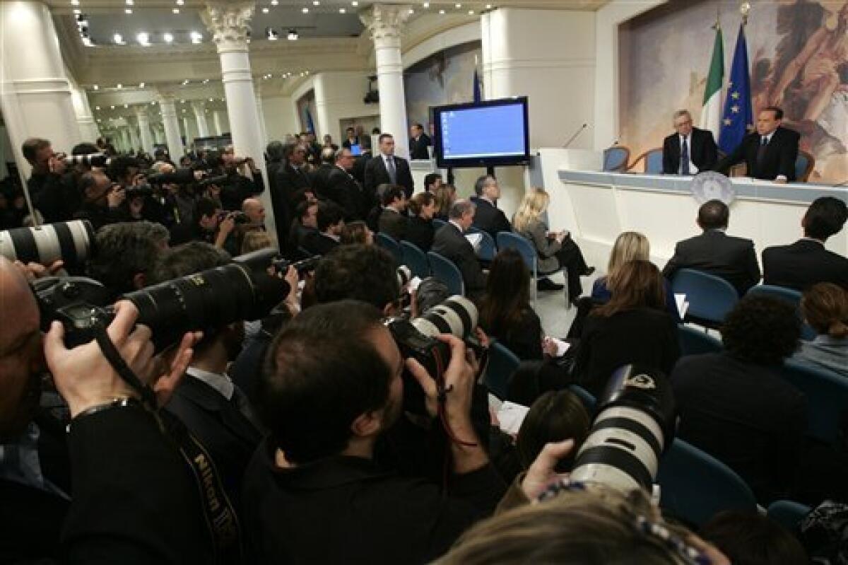 Italian Premier Silvio Berlusconi, right, and Finance Minister Giulio Tremonti, face a press conference at Chigi Premier's palace, in Rome, Wednesday, Feb. 16, 2011. Berlusconi says he is not worried by an impending prostitution trial, in his first public comments since he was indicted. The 74-year-old Italian leader was ordered Tuesday to stand trial on charges he paid a 17-year-old Moroccan girl for sex, and then used his influence to cover it up. (AP Photo/Riccardo De Luca)