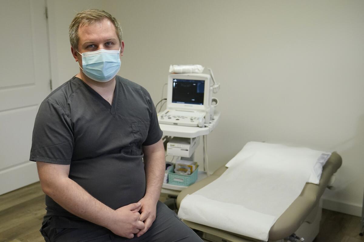 Medical student Ian Peake sits in an ultrasound room.