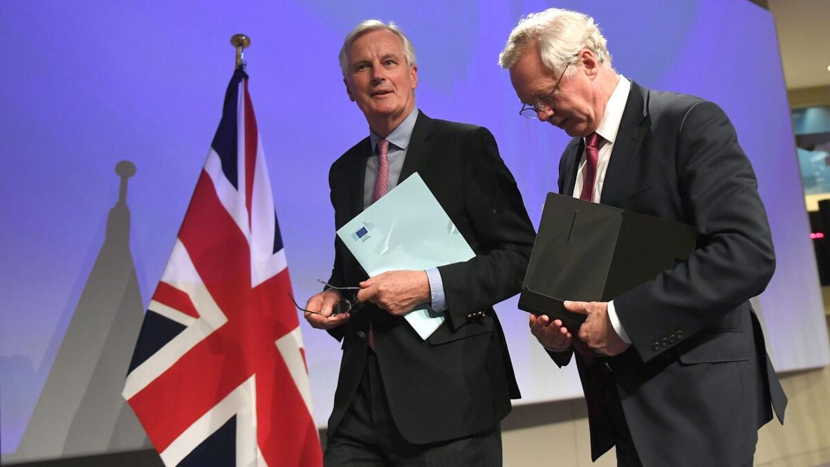 Michel Barnier, left, the European Union's lead negotiator, and David Davis, Britain's top Brexit negotiator, after a news conference at the end of the first day of divorce talks Monday at the European Commission in Brussels.