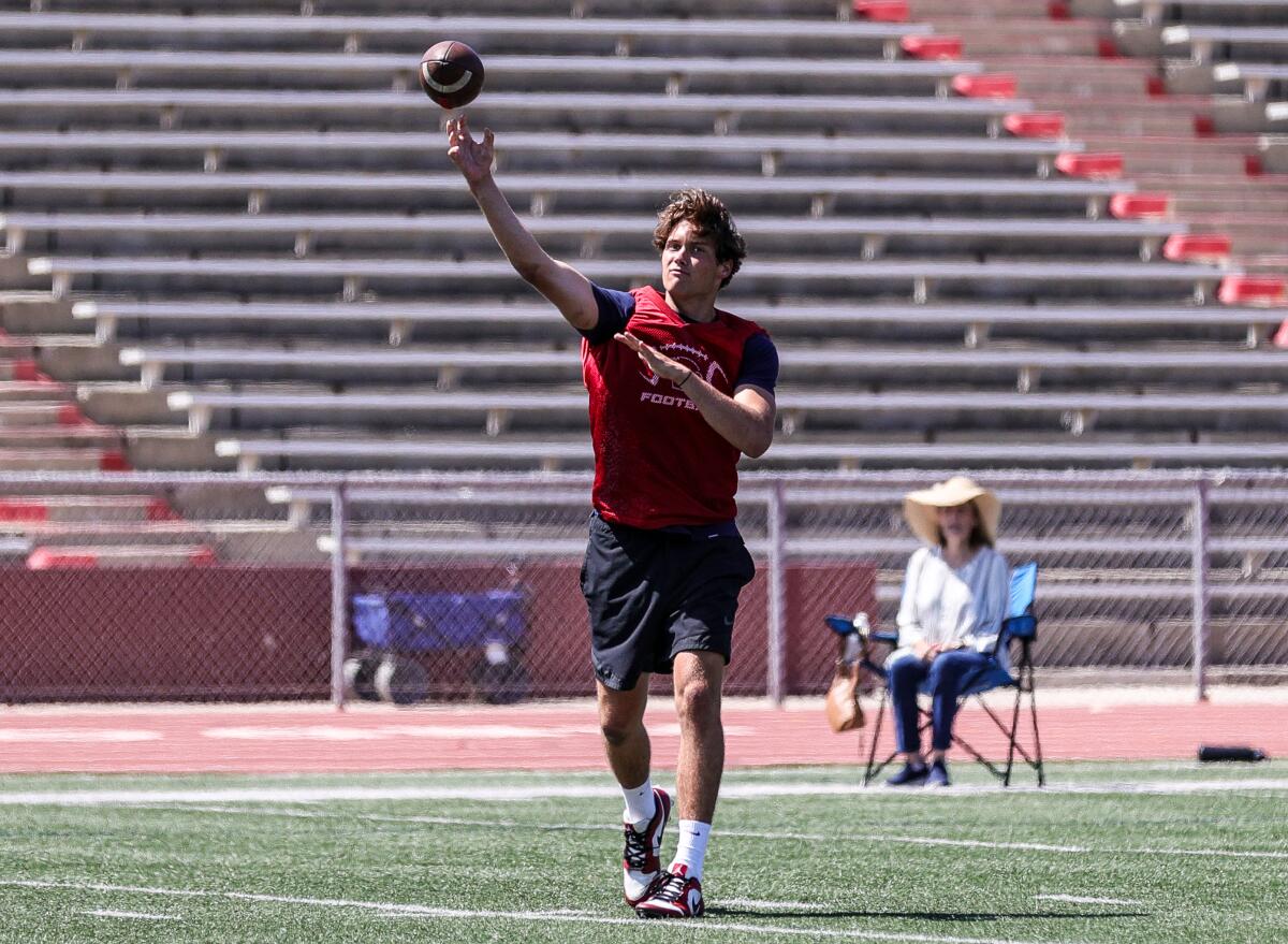 Cole Leinart balances a football.