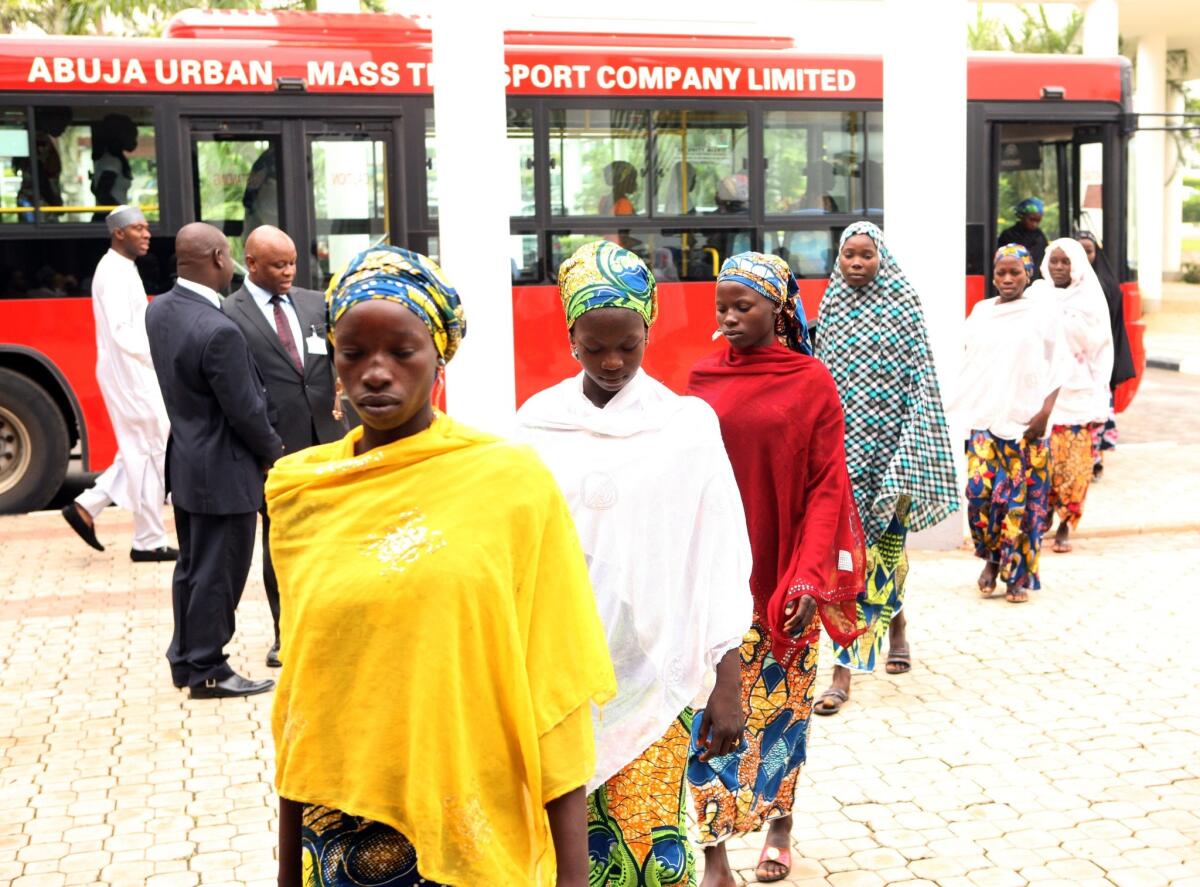 Some of the Chibok schoolgirls who escaped Islamist captors alight from a bus to attend a meeting with Nigerian President Goodluck Jonathan in Abuja on Tuesday.