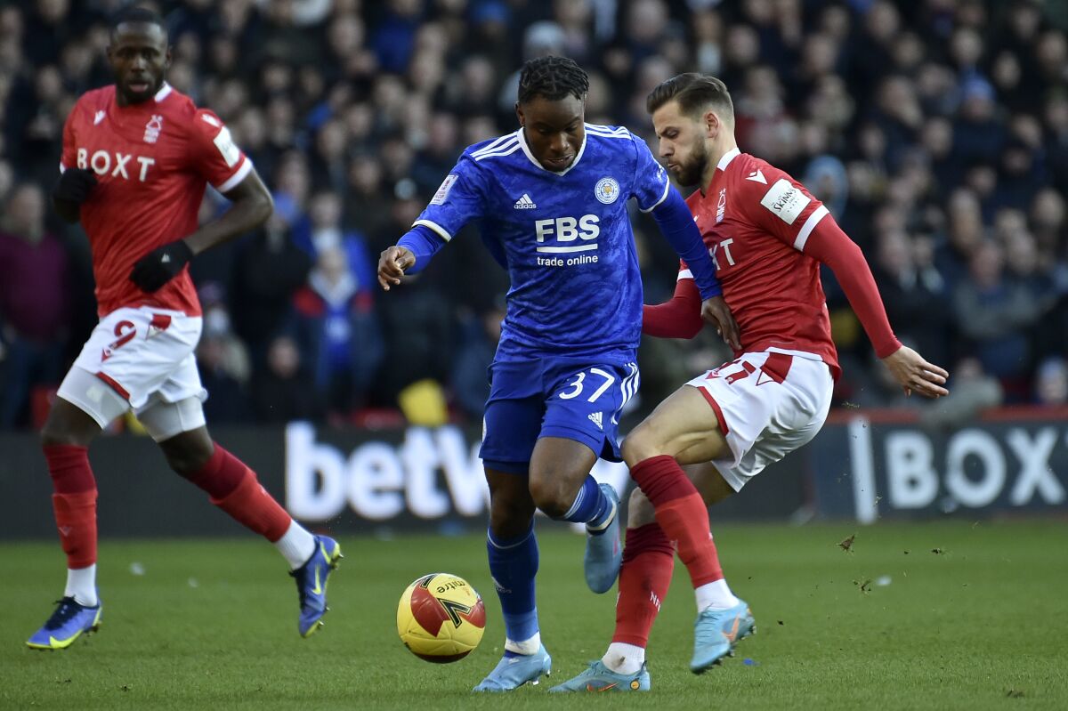 Nottingham Forest's Philip Zinckernagel, right, tries to tackle Leicester's Ademola Lookman during the English FA Cup fourth round soccer match between Nottingham Forest and Leicester City at the City Ground, Nottingham, England, Sunday, Feb. 6, 2022. (AP Photo/Rui Vieira)