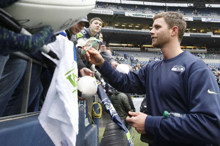 Seattle kicker Steven Hauschka signs autographs before the NFC championship game.