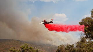 A firefighting plane dumps retardant on a fire near Wooroloo, north east of Perth, Australia.