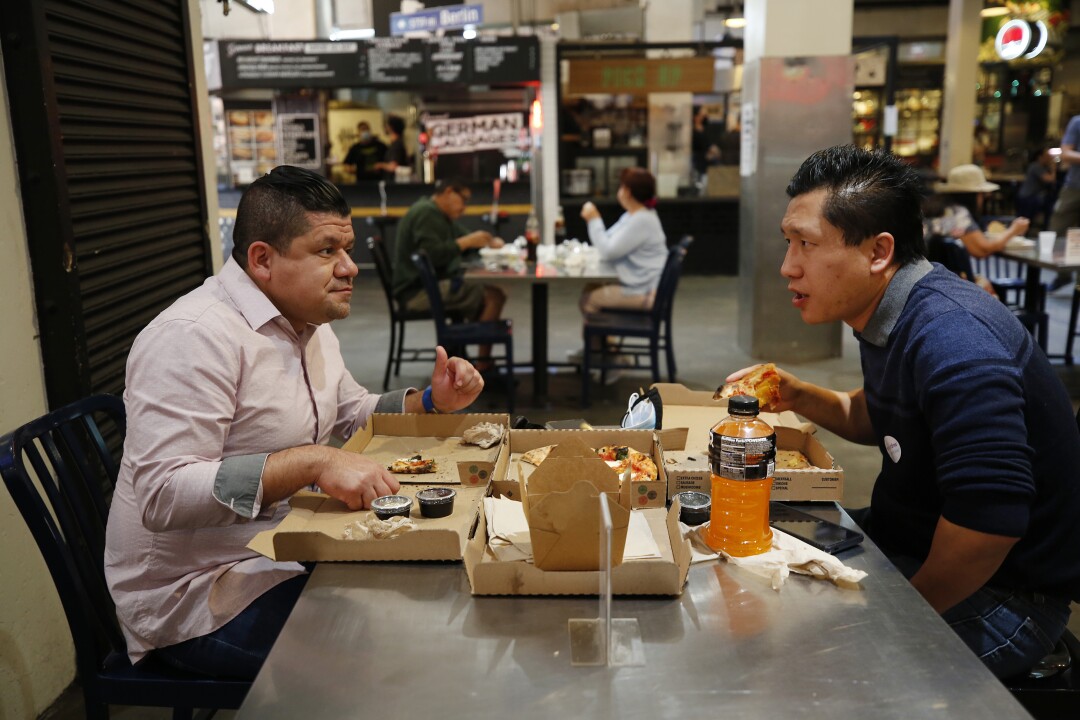 Los Angeles City workers Harold Arrivillaga, 41, left, and Jason Wong, 38.