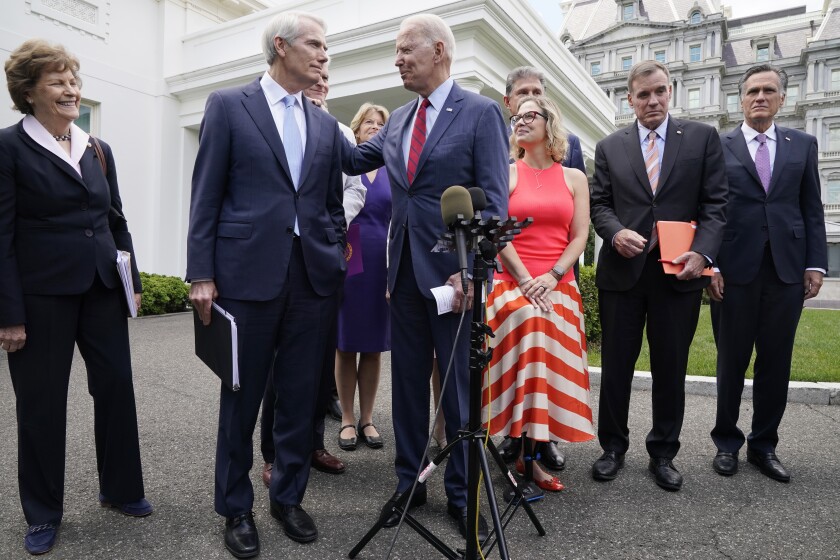 President Biden speaks with Sen. Rob Portman (R-Ohio) and other senators
