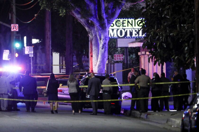 El Monte, CA - June 14: Law enforcement personnel investigate the scene after a shooting left two officers and a suspect dead Tuesday, June 14, 2022 in El Monte, CA. (Robert Gauthier / Los Angeles Times)