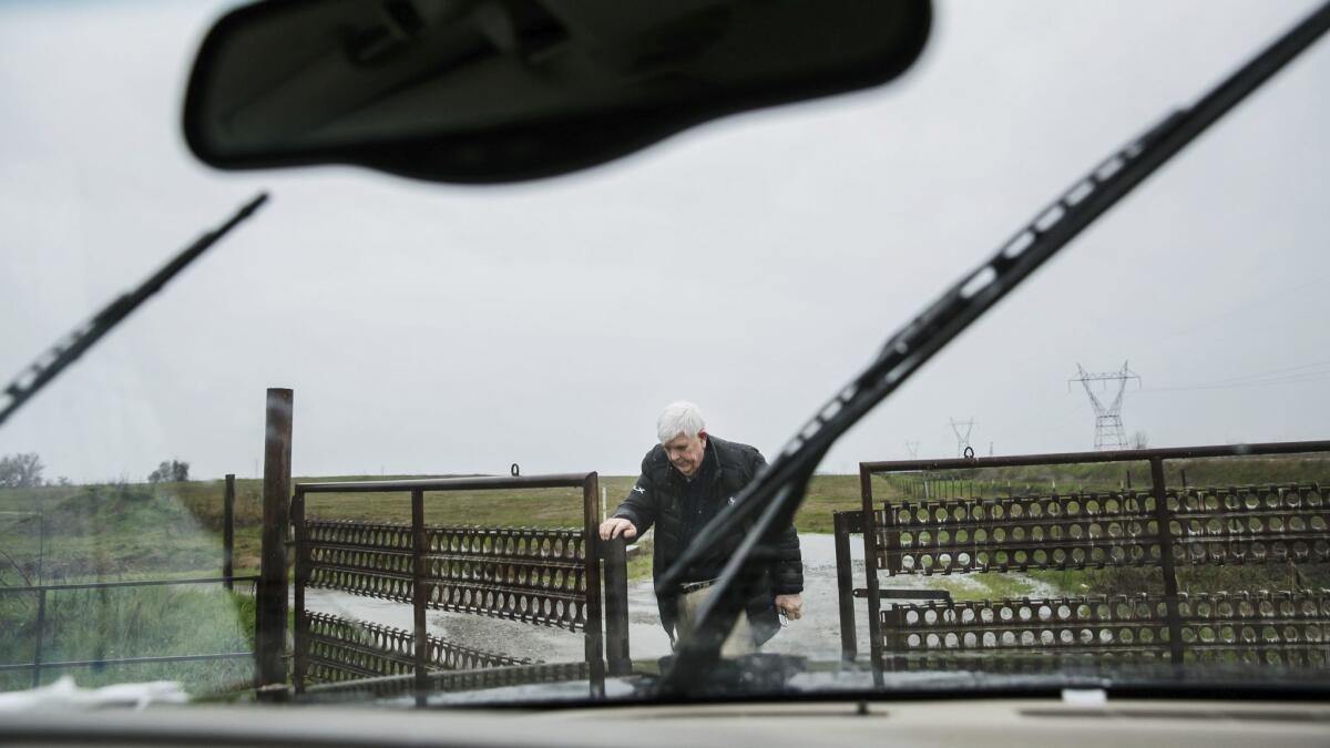 Charlie Matthews opens the gate to this property in Marysville.